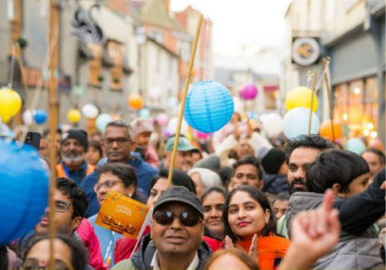 Crowd at a multicultural street celebration with colourful paper lanterns