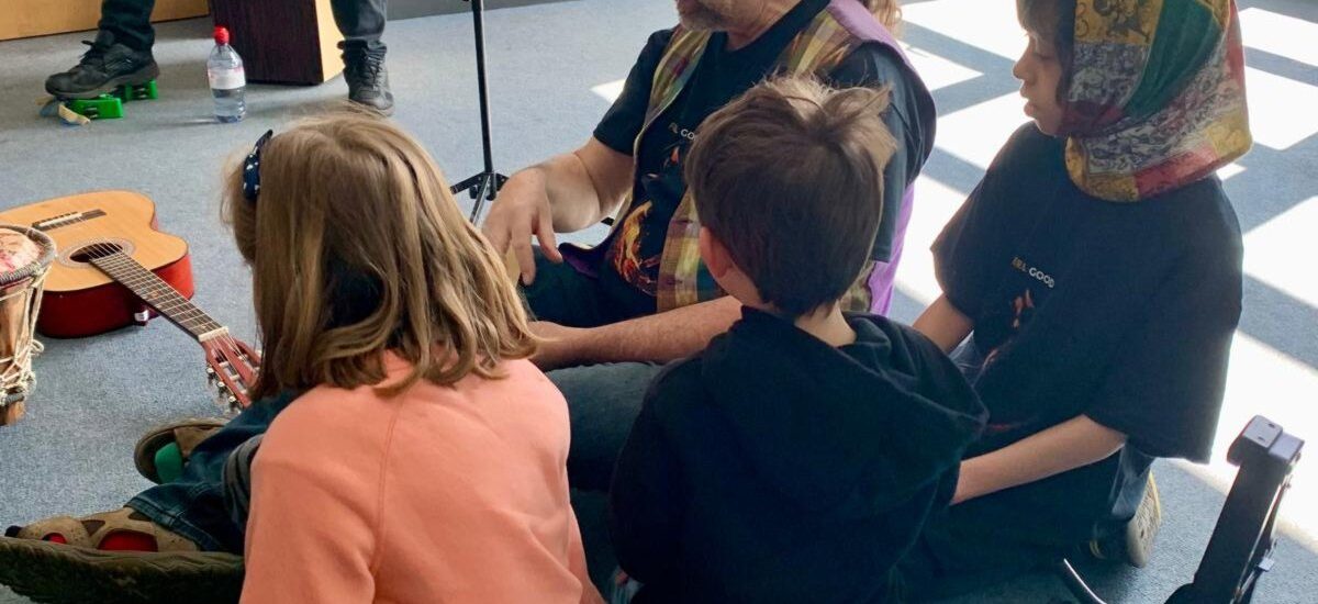 children in a group listening to music