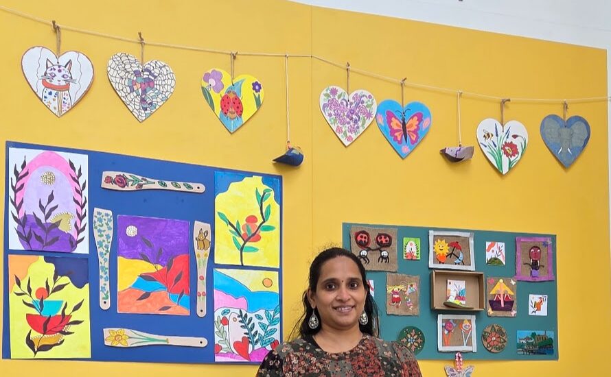 lady stood in front of a wall of community art works