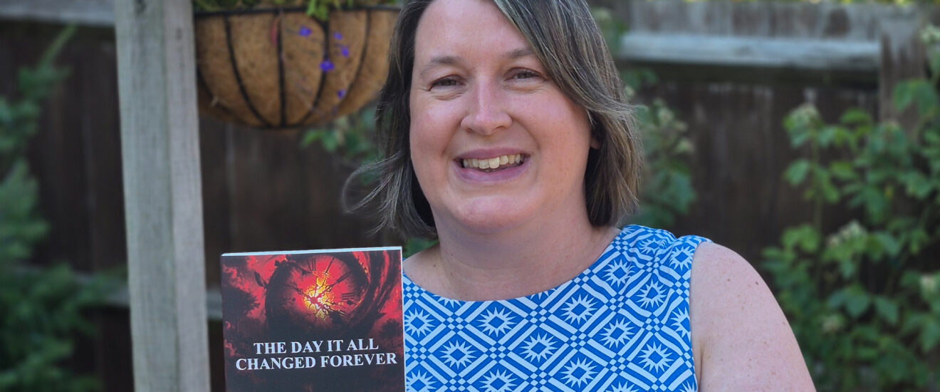 woman stood in garden holding a book
