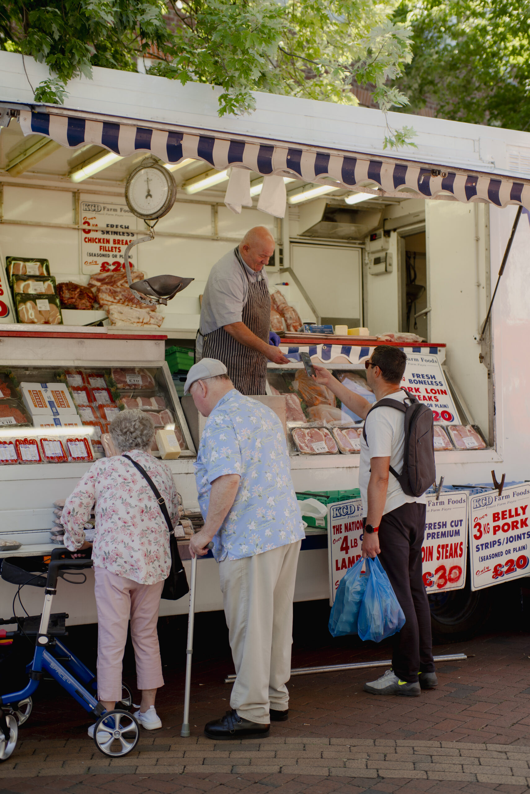 The public purchasing goods from a stall at the Rugby Market.